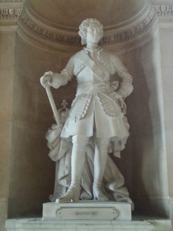 Louis XV in marble on the ground floor of Versailles.