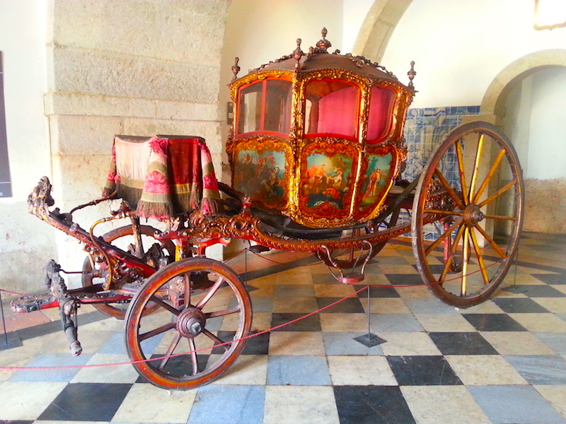 A Cinderella-like 18C carriage in the vestibule.