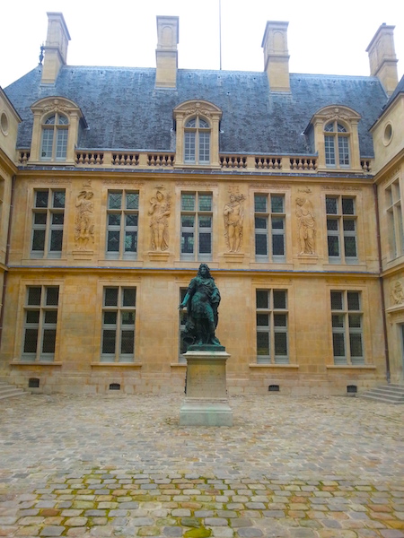 An equestrian statue of Louis XIV presides over a 17C courtyard of the museum.